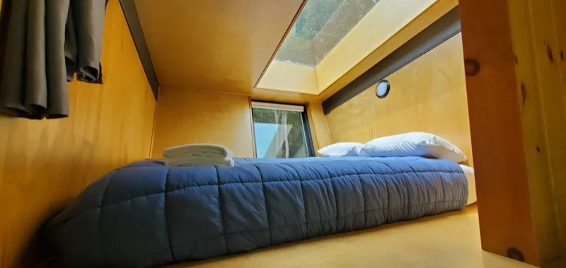 Queen bed inside a glamping pod