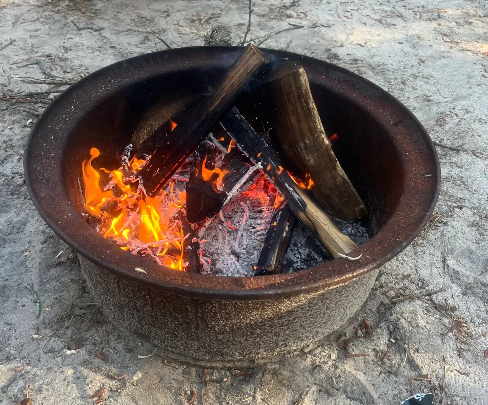 A campfire glowing at dusk